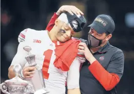  ?? CHRIS GRAYTHEN/GETTY ?? OSU’s Justin Fields, left, and head coach Ryan Day react after defeating Clemson in the College Football Playoff semifinals in New Orleans, Louisiana.