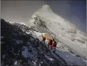  ?? TASHI TSERING — XINHUA ?? Members of a Chinese surveying team head for the summit of Mount Everest on May 27.