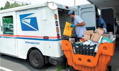  ?? Photograph: Valérie Macon/AFP via Getty Images ?? A mail carrier in Los Angeles, California.