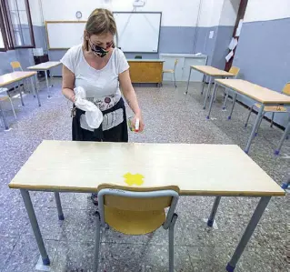  ?? ?? Prevenzion­e
Una operatrice pulisce un’aula prima degli esami di maturità nel liceo Mamiani (foto Guaitoli)