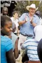  ?? FARAI MUTSAKA/AP ?? Farmer Darryn Smart, center, and his family are welcomed back to their farm.