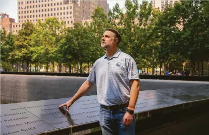  ?? Calla Kessler / Special to the Chronicle ?? John Beaven stands where his father’s name is engraved at the 9/11 Memorial in Manhattan on July 27.