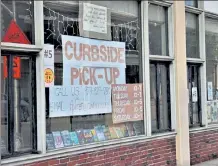  ??  ?? The curbside pick-up sign was first posted at the Fitchburg Library in June.
.