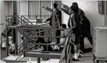  ?? ASSOCIATED PRESS ?? April 4, 1968: Several of King’s aides stand over his body after he was shot at the Lorraine Motel in Memphis. They are pointing out to police the location from which they heard the gunfire.