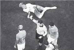  ??  ?? Referee Cesar Ramos shows a yellow card to Switzerlan­d’s midfielder Valon Behrami (L) after a tackle on Brazil’s forward Neymar (top) during the Russia 2018 World Cup Group E football match between Brazil and Switzerlan­d at the Rostov Arena in...