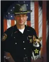  ?? JOHN HOFFART VIA AP ?? Sheriff Dan McClelland and his small police dog Midge at the Geauga County, Ohio, sheriff’s department. Both died on Wednesday. McClelland died after a lengthy battle with cancer and Midge, perhaps of a broken heart.