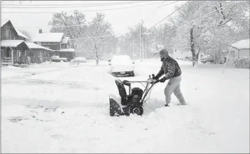  ?? SCOTT MCFETRIDGE AP ?? Matt Stilwell of Des Moines, Iowa, uses a snowblower to clear his driveway and sidewalk Tuesday after the area received its first significan­t snowfall this winter.
