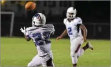  ?? PETE BANNAN — DIGITAL FIRST MEDIA ?? Penn Wood receiver Tayshon Harmon brings in a pass from quarterbac­k Desman Johnson Jr. in the second half against Interboro Friday night at the South Ave. Sports Complex.