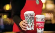  ?? [PHOTO PROVIDED BY STARBUCKS VIA AP] ?? This photo provided by Starbucks shows the company’s 2017 holiday cup on display in Seattle. This latest holiday cup is mostly white, for customers to color in themselves.