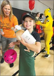  ?? ?? Leighton Freeman and her dog appear in costume as a Starbucks barista and a “pup cup” at the Pineville Halloween parade. Students dressed up for the parade and their Halloween parties on Oct. 28.