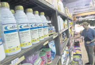  ??  ?? STILL ON SALE: Bottles of paraquat are displayed for sale at a shop in Bangkok. Authoritie­s have restricted use of the toxic weedkiller, rather than opting for a ban.