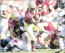  ?? MICHAEL CHANG / GETTY IMAGES ?? Running back Dalvin Cook says the Seminoles aren’t worrying now about the earlier losses, but instead are committed to finishing the season with a strong showing.