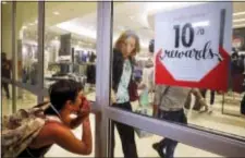  ?? JEFF ROBERSON - THE ASSOCIATED PRESS ?? A protester yells as a woman rushes to close the doors to a department store as protesters march through West County Mall in response to a not-guilty verdict in the trial of former St. Louis police officer Jason Stockley Saturday, in Des Peres, Mo....