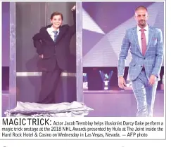  ??  ?? MAGIC TRICK:
Actor Jacob Tremblay helps illusionis­t Darcy Oake perform a magic trick onstage at the 2018 NHL Awards presented by Hulu at The Joint inside the Hard Rock Hotel & Casino on Wednesday in Las Vegas, Nevada. — AFP photo