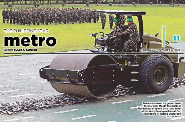  ?? KRIZJOHN ROSALES ?? Firearms seized by government forces from Maute terrorists in Marawi are crushed by a road roller at the Army headquarte­rs at Fort Bonifacio in Taguig yesterday.