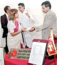  ??  ?? A stamp and a first day cover were issued in memory of Deshamanya Vidya Jyothi Dr. Philip Revatha (Ray) Wijewarden­e yesterday at the inaugurati­on of the ‘Sahasak Nimavum 2014’ Exhibition. The stamp and the first day cover are seen being presented to...