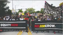  ?? LINDSEY WASSON/ REUTERS ?? People demonstrat­e during a Juneteenth Freedom March in Seattle on Friday.