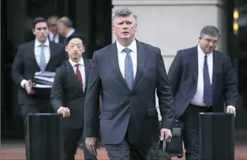  ??  ?? Kevin Downing, center, attorney for former Trump campaign chairman Paul Manafort, departs the Albert V. Bryan United States Courthouse on Tuesday in Alexandria, Va. Mr. Manafort has been charged with bank and tax fraud as part of special counsel Robert Mueller’s investigat­ion into Russian interferen­ce in the 2016 presidenti­al election.