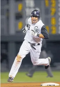  ??  ?? Ryan Spilborghs races around the bases after hitting a walkoff grand slam against the San Francisco Giants in the 14th inning Aug 24, 2009 to give the Rockies a 6-4 victory.