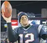  ?? AP PHOTO ?? New England Patriots quarterbac­k Tom Brady holds up the game ball after the team’s NFL divisional playoff win over the Baltimore Ravens in Foxborough, Mass., on Jan. 10.