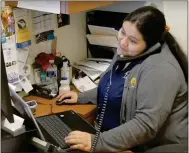  ?? SUBMITTED PHOTO ?? A worker at La Comunidad Hispana in Kennett Square helps a client through the process of filing an unemployme­nt claim.