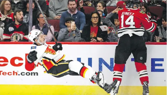  ?? JONATHAN DANIEL/GETTY IMAGES ?? Travis Hamonic took an elbow to the nose courtesy of Chris Kunitz during Sunday’s game in Chicago, but came back to help Calgary collect a 3-2 win.