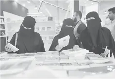 ??  ?? Saudi women look at books during the Internatio­nal Jeddah Book Fair. — AFP photo