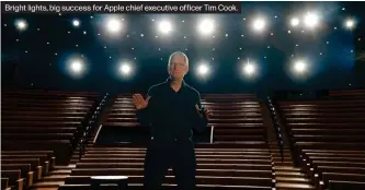  ??  ?? Bright lights, big success for Apple chief executive officer Tim Cook.