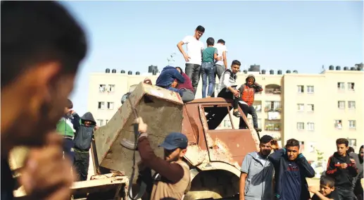  ?? (Reuters) ?? GAZANS INSPECT the damage after an airstrike.