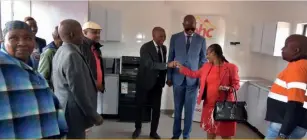  ?? ?? Assistant Minister of Local Government and Rural Developmen­t Hon. Talita Monnakgotl­a applauding BHC Acting CEO Mr. Nkaelang Matenge for the great work the Corporatio­n has done for Sedibeng sa
Lerato. Looking on is the BHC Board Chairman Mr. Moemedi Gabana