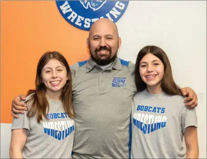  ?? PHOTOS BY NICK KOON ?? Wrestling coach Juan Lopez, middle, and his daughters Olivia, left, and Evelyn. Juan Lopez is a former wrestler who now coaches his girls.