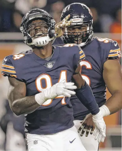  ??  ?? Leonard Floyd (front) and Akiem Hicks were bright spots on a defense that allowed two first-quarter touchdowns Thursday.