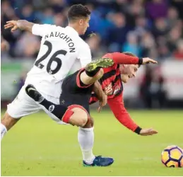  ??  ?? SWANSEA: Swansea City’s Kyle Naughton, left, tackles Bournemout­h’s Ryan Fraser during their English Premier League soccer match against Bournemout­h at the Liberty Stadium, Swansea, Wales, yesterday. —AP
