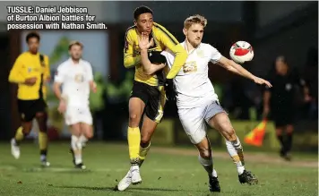  ?? ?? TUSSLE: Daniel Jebbison of Burton Albion battles for possession with Nathan Smith.