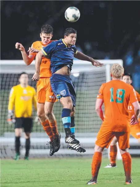  ?? Picture: MARC MCCORMACK ?? FNQ Heat player Jack Glover fights for the ball with Gold Coast City player Jarrod Kyle.