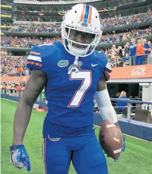  ?? TOM PENNINGTON/GETTY IMAGES ?? Florida’s Duke Dawson returned an intercepti­on for a touchdown in the Gators’ opener against Michigan, one of a pair of pick-sixes for the defense in game that saw the unit beaten up by the Wolverines.