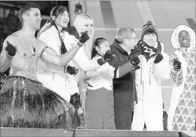  ?? KIRSTY WIGGLESWOR­TH/AP ?? “Shirtless Tongan” Pita Taufatofua; Lindsey Vonn, third from left; and IOC President Thomas Bach (dark coat) at the closing ceremony.
