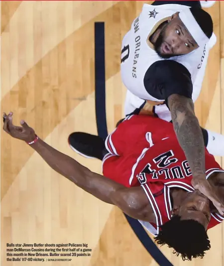  ??  ?? Bulls star Jimmy Butler shoots against Pelicans big man DeMarcus Cousins during the first half of a game this month in New Orleans. Butler scored 39 points in the Bulls’ 117- 110 victory.
| GERALD HERBERT/ AP