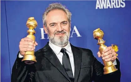  ?? MIKE BLAKE/REUTERS ?? Sam Mendes poses backstage with his awards for Best Director - Motion Picture and Best Motion Picture - Drama for “1917” at the 77th Golden Globe Awards in Beverly Hills, Calif., earlier this year.