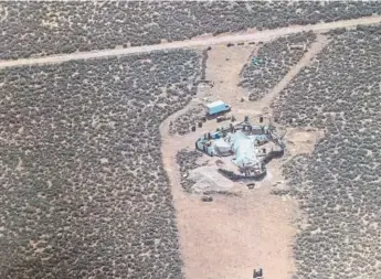  ?? The Associated Press ?? An aerial photo of the compound in Amalia, N.M., provided by the Taos County Sheriff’s Office.
