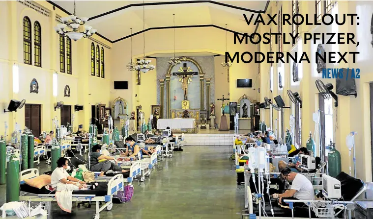  ?? —GRIG C. MONTEGRAND­E ?? A CROSS IN THEIR MIDST The Quezon City General Hospital and Medical Center has been forced to convert its chapel into a COVID-19 ward, an example of how the recent spike in cases driven by the Delta variant of the coronaviru­s is stretching the capacity and resources of the country’s health-care system.