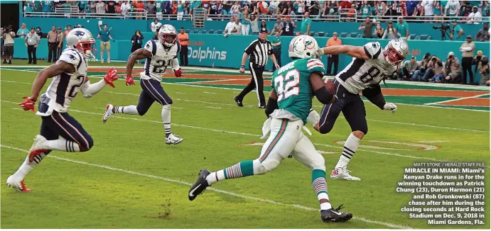  ?? MATT sTonE / HErAld sTAFF FIlE ?? MIRACLE IN MIAMI: Miami’s Kenyan Drake runs in for the winning touchdown as Patrick Chung (23), Duron Harmon (21) and Rob Gronkowski (87) chase after him during the closing seconds at Hard Rock Stadium on Dec. 9, 2018 in Miami Gardens, Fla.