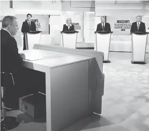  ?? MARK BLINCH / AFP / GETTY IMAGES ?? Liberal Leader Justin Trudeau, from left, Green Party Leader Elizabeth May, former NDP leader Thomas Mulcair and former Conservati­ve leader Stephen Harper square off in August 2015 for a leaders’ debate, moderated by Paul Wells, foreground, of Maclean’s magazine.