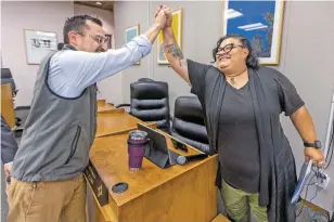  ?? LUIS SÁNCHEZ SATURNO/THE NEW MEXICAN ?? City Councilor Michael Garcia high-fives Assistant City Clerk Geralyn Cardenas at City Hall on Monday after Cardenas was appointed interim clerk.