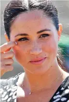  ??  ?? Protection: The Duchess with her necklace in South Africa this week