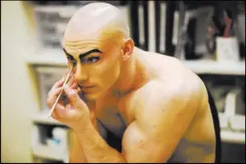  ??  ?? Montgomery, who performs five nights a week in “Le Reve,” applies makeup backstage at Wynn Las Vegas.