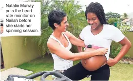  ??  ?? Natalie Murray puts the heart rate monitor on Nailah before she starts her spinning session.