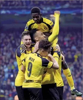  ?? SUSANA VERA / REUTERS ?? Borussia Dortmund players celebrate equalizing against Real Madrid in Wednesday’s UEFA Champions League Group F match at Santiago Bernabeu in Madrid.