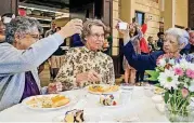  ??  ?? An ice cream toast is made for Sister Betty Elmer, center, during her retirement celebratio­n at Mount St. Mary High School in Oklahoma City. Flanking her are Sister Diane Koorie, left, and Sister Elena Gonzalez. All three are members of the Sisters of Mercy religious order.