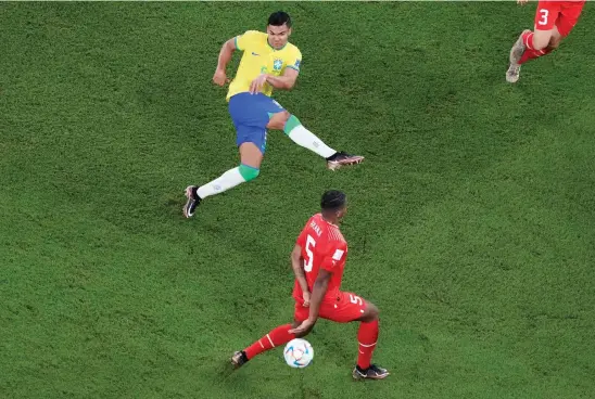  ?? AP ?? Brazil’s Casemiro, top, scores his side’s opening goal during the World Cup Group G match against Switzerlan­d at the Stadium 974 in Doha Monday.